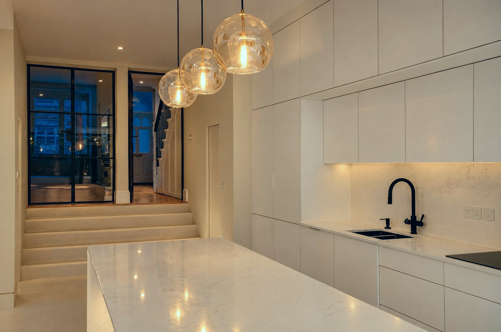 Kitchen with a black steel glazed screen and door to the hall