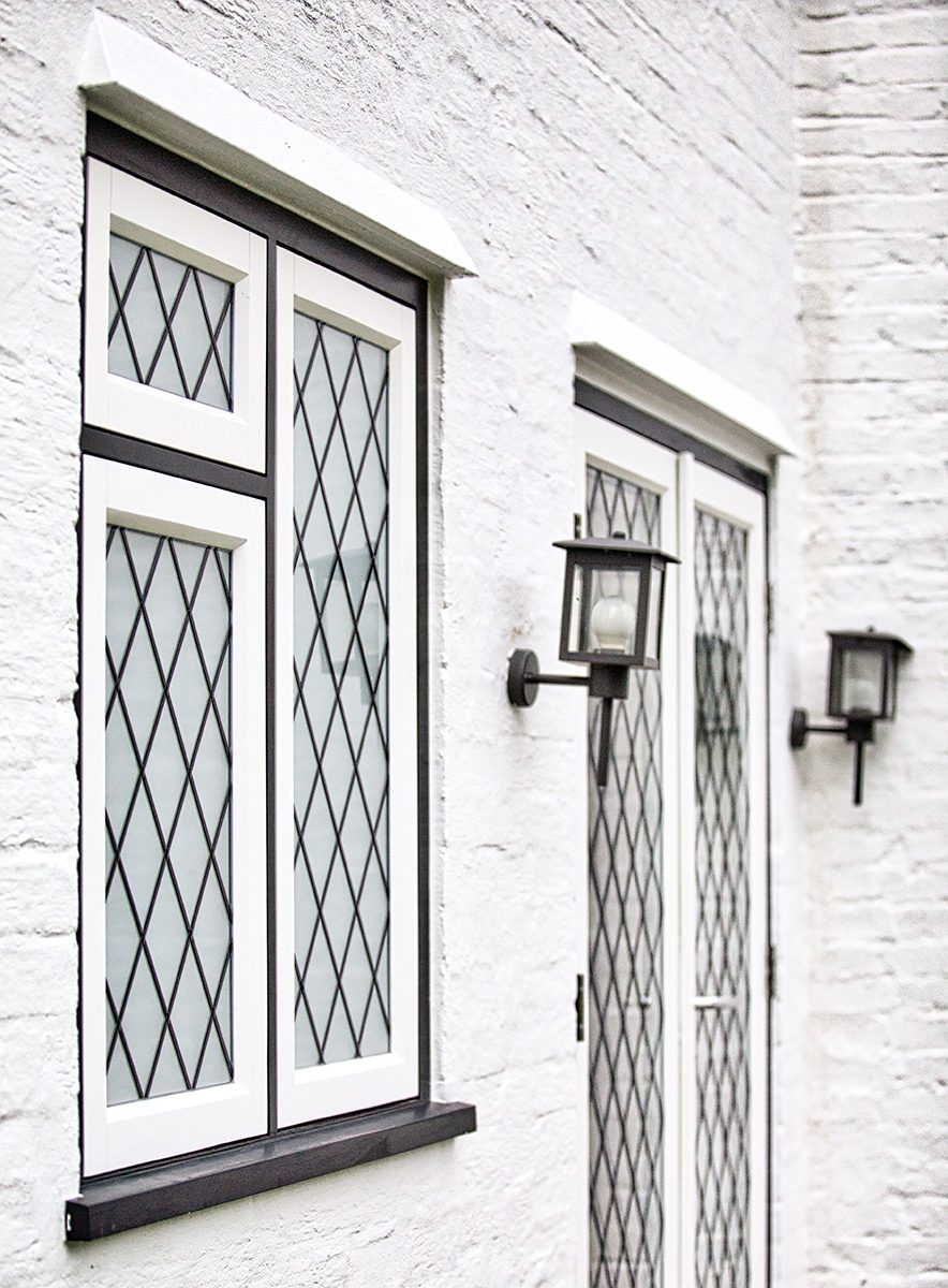 Leaded casements and a glazed door with wall lights